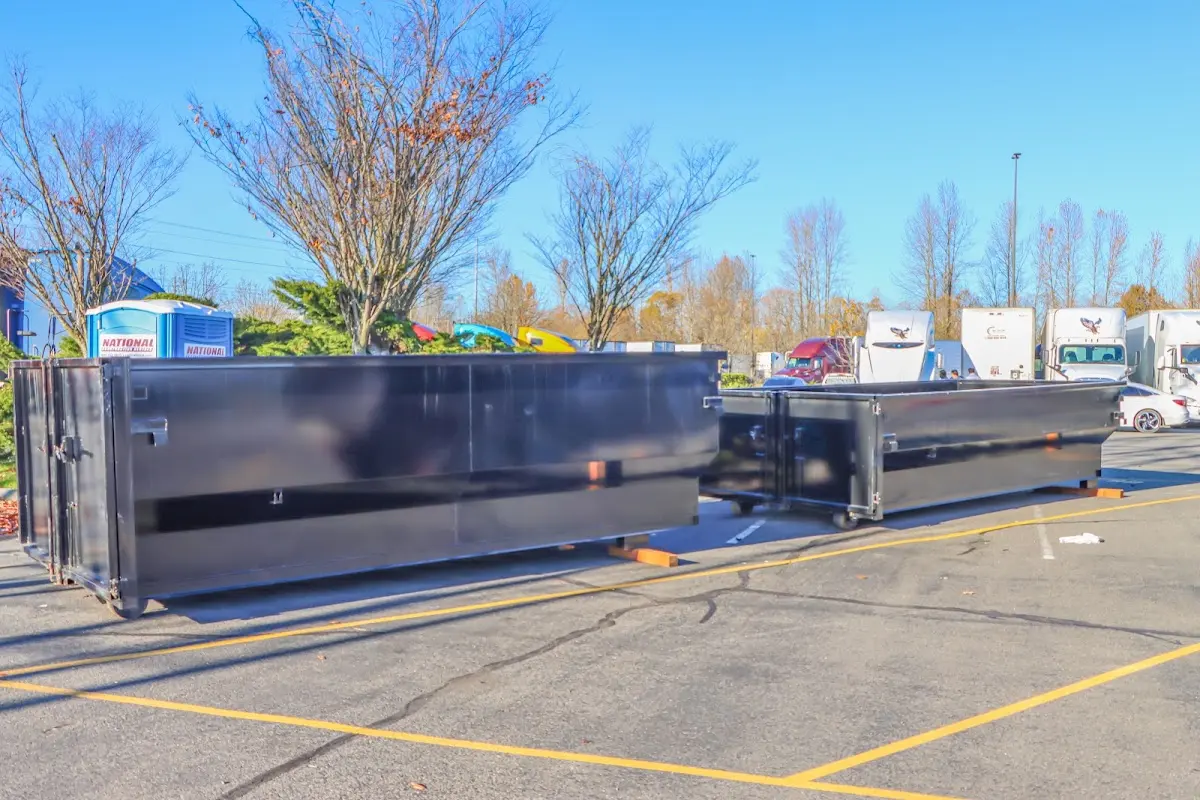 Professional dumpster rental service with roll-off container on residential driveway in Farragut